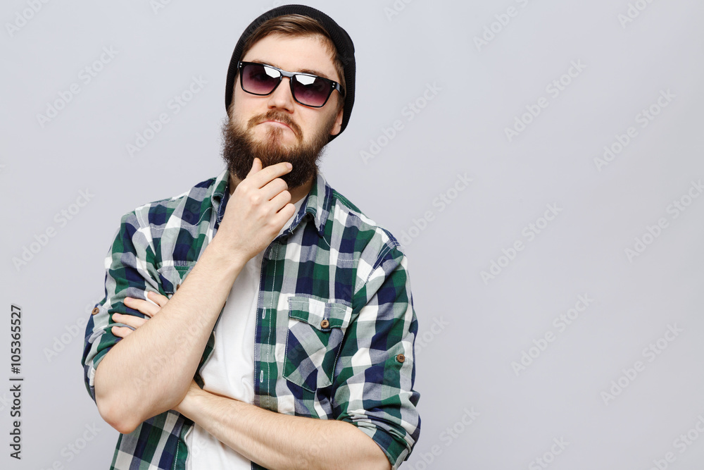 Young brutal man thinking on white background, in studio Young brutal man thinking on white background, in studio