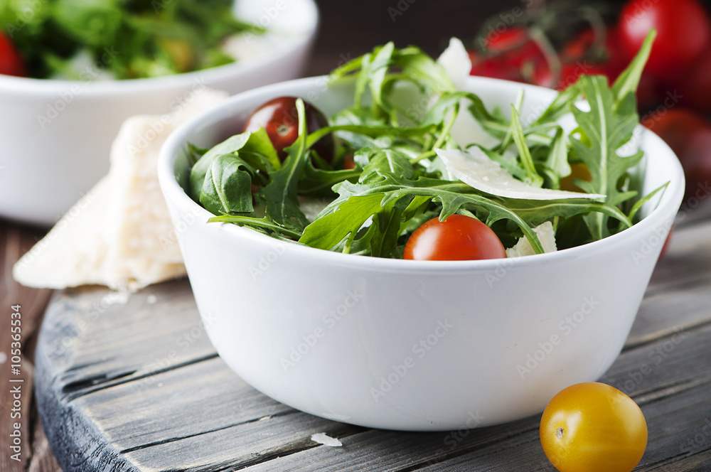 Healthy salad with rocket, tomato and parmesan cheese Healthy salad with rocket, tomato and parmesan cheese