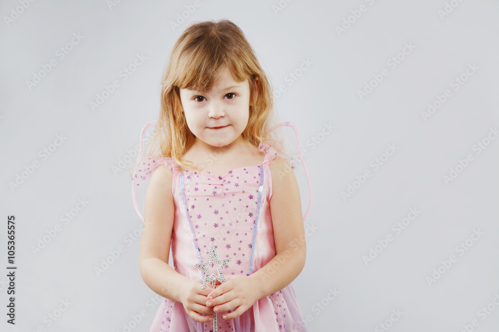 Pretty little girl posing with magic stick on white background Pretty little girl posing with magic stick on white background
