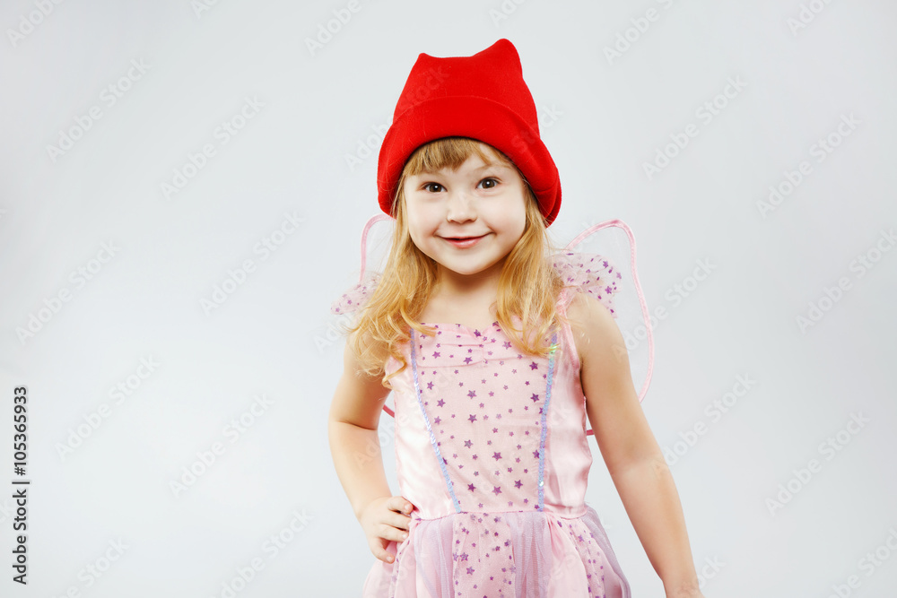 Little smiling girl posing on white background in studio