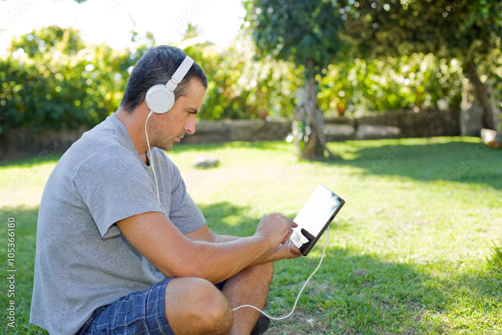 man relaxing with tablet pc man relaxing with tablet pc