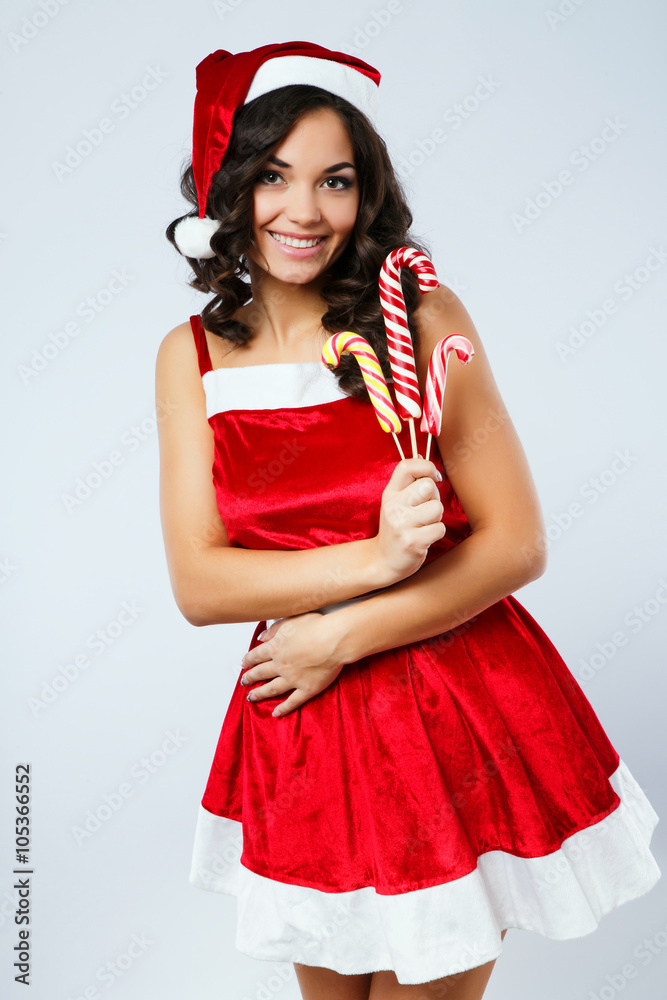Beautiful brunette girl posing with three colorful candies