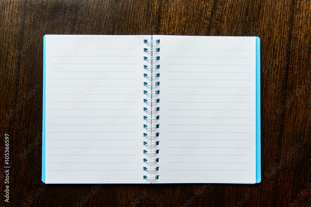 Spiral notebook on wood background Spiral notebook on wood background