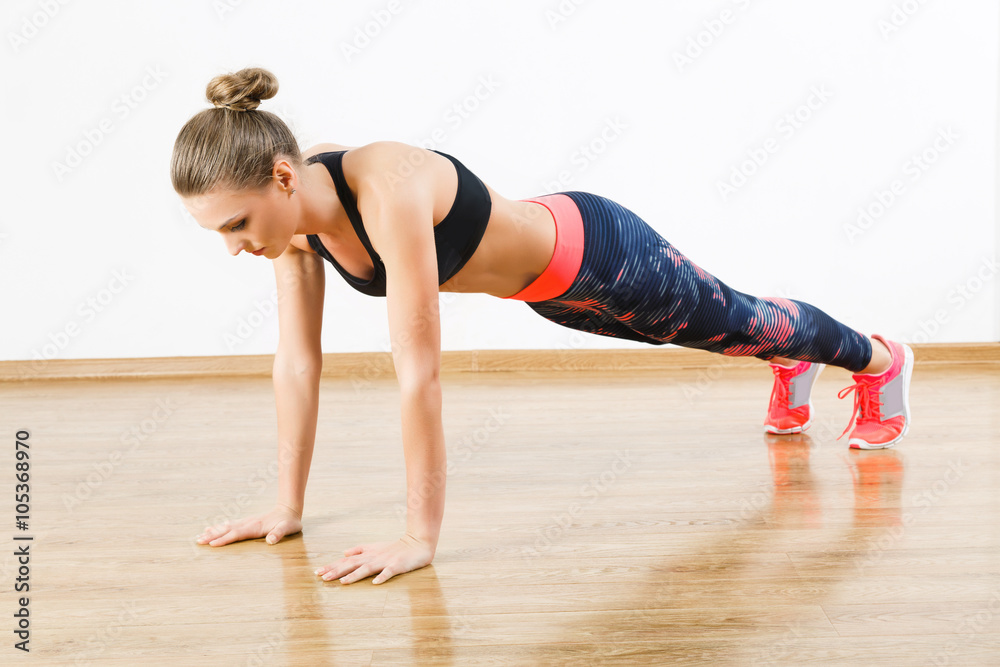 Cute fit girl doing physical exercises at gym Cute fit girl doing physical exercises at gym