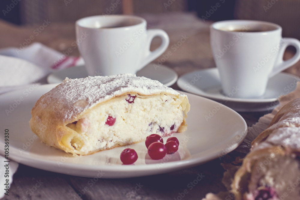 Strudel or pie with cranberries and cheese and two cups of coffee