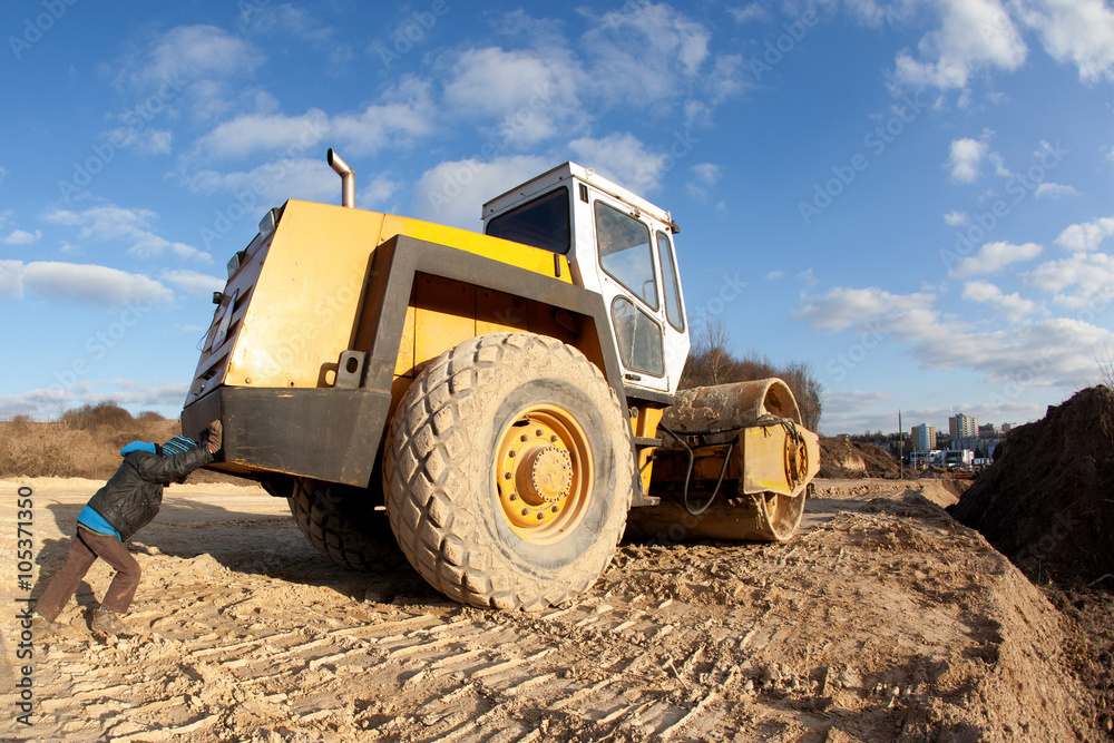 Obraz premium strong boy pushes a roller 