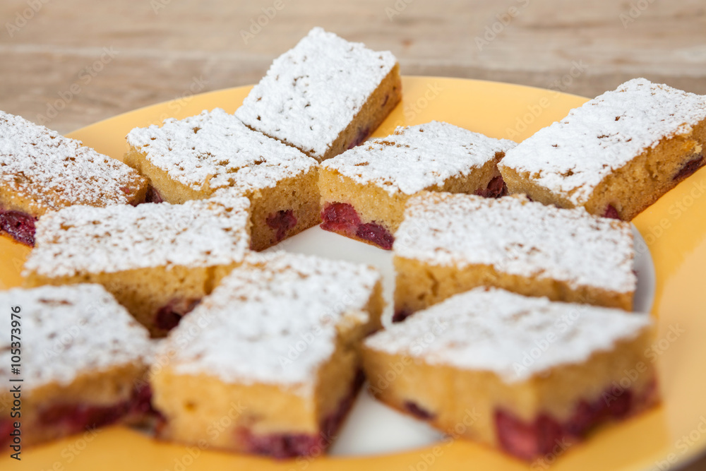 Slice of cherry pie on a plate sprinkled with sugar