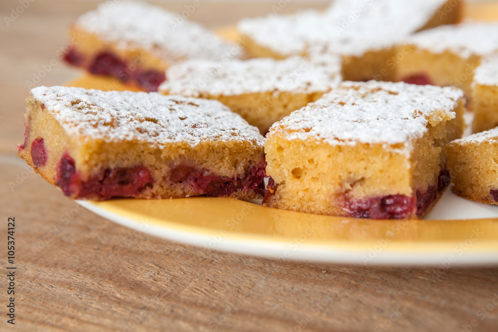 Slice of cherry pie on a plate sprinkled with sugar