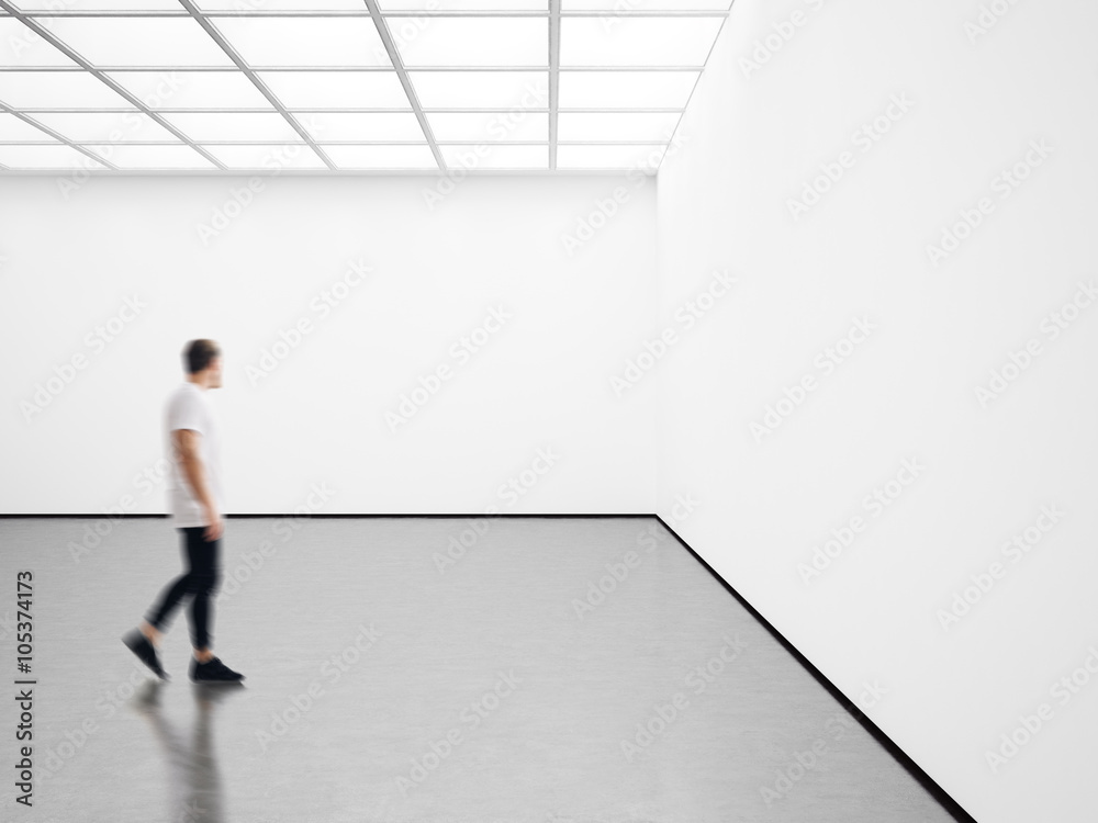 Photo of young man in modern gallery looking at the empty canvas. Blank mockup, motion blur Photo of young man in modern gallery looking at the empty canvas. Blank mockup, motion blur