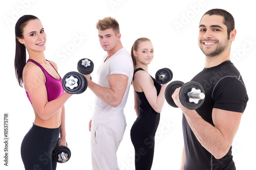 happy men and women in sportswear doing exercises with dumbbells