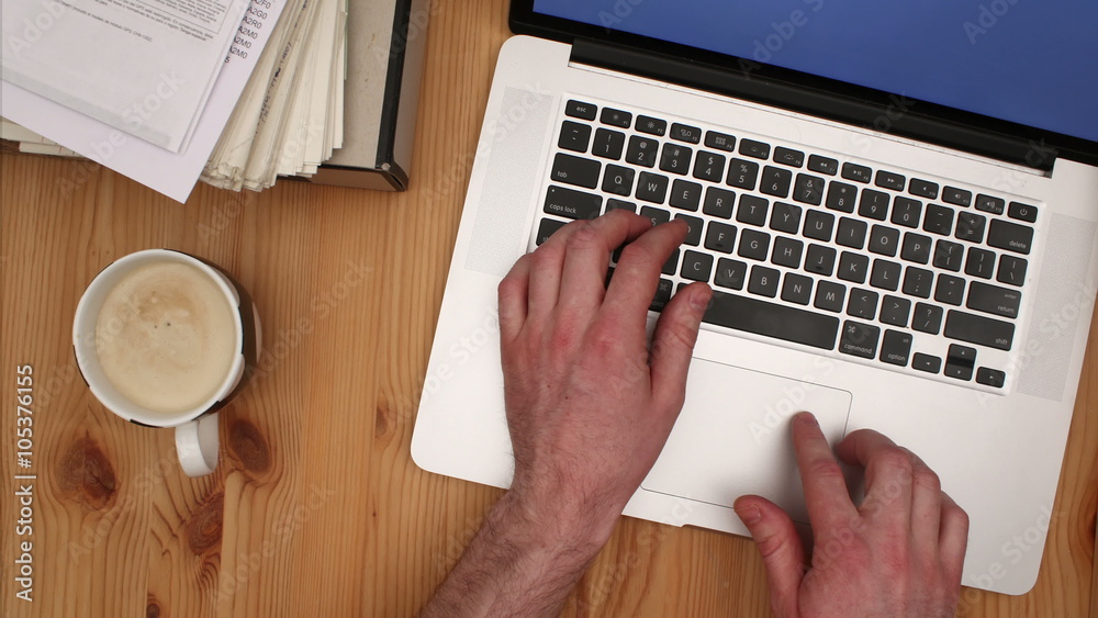 Man working on laptop & pulsing cup of coffee - Cinemagraph.