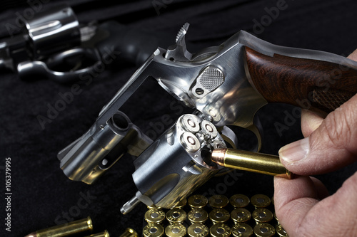 Man loading compact magnum revolver firearm photo