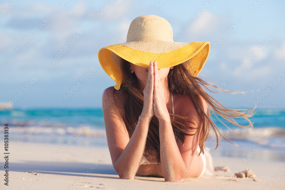 portrait of young woman in sun hat at beach