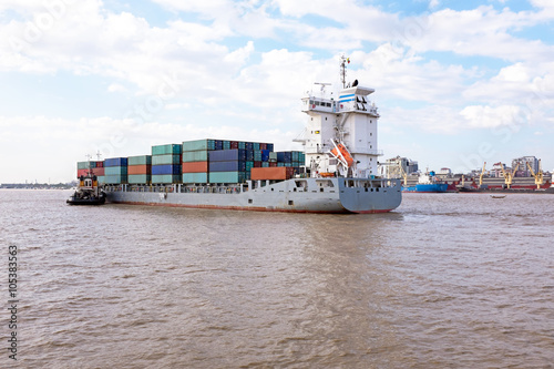 Containership on the Yangon river near Yangon in Myanmar photo