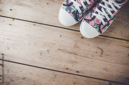 Colorful sneakers on wooden floor