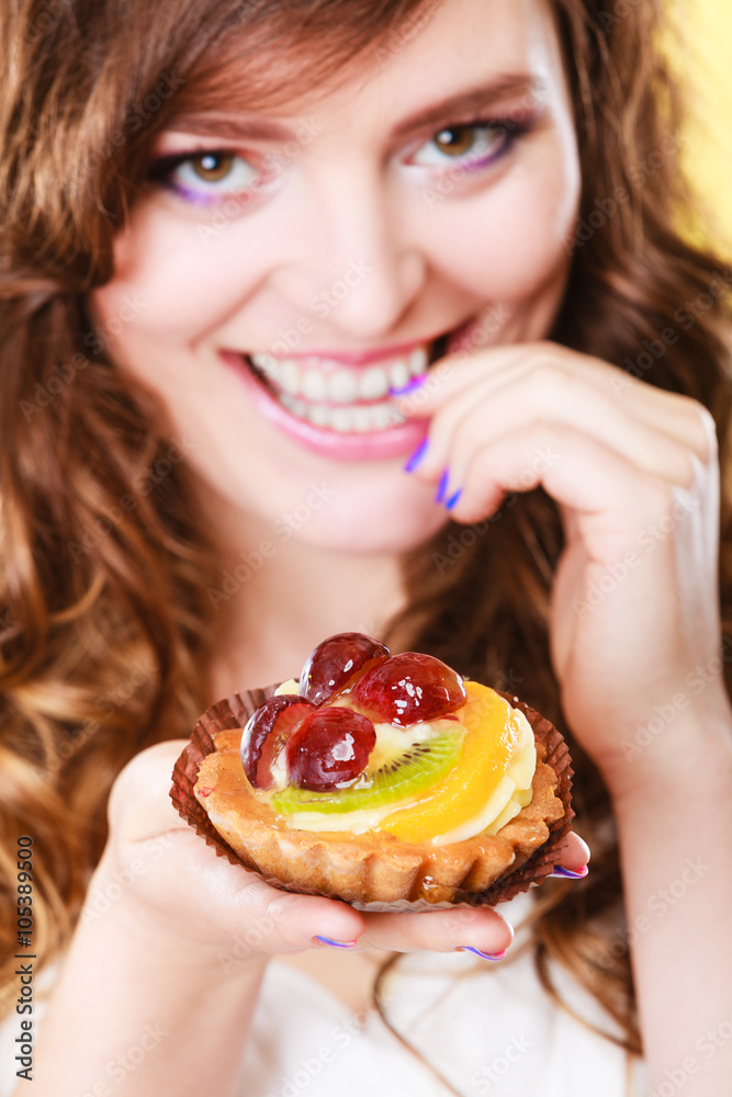 Closeup flirty woman eating fruit cake