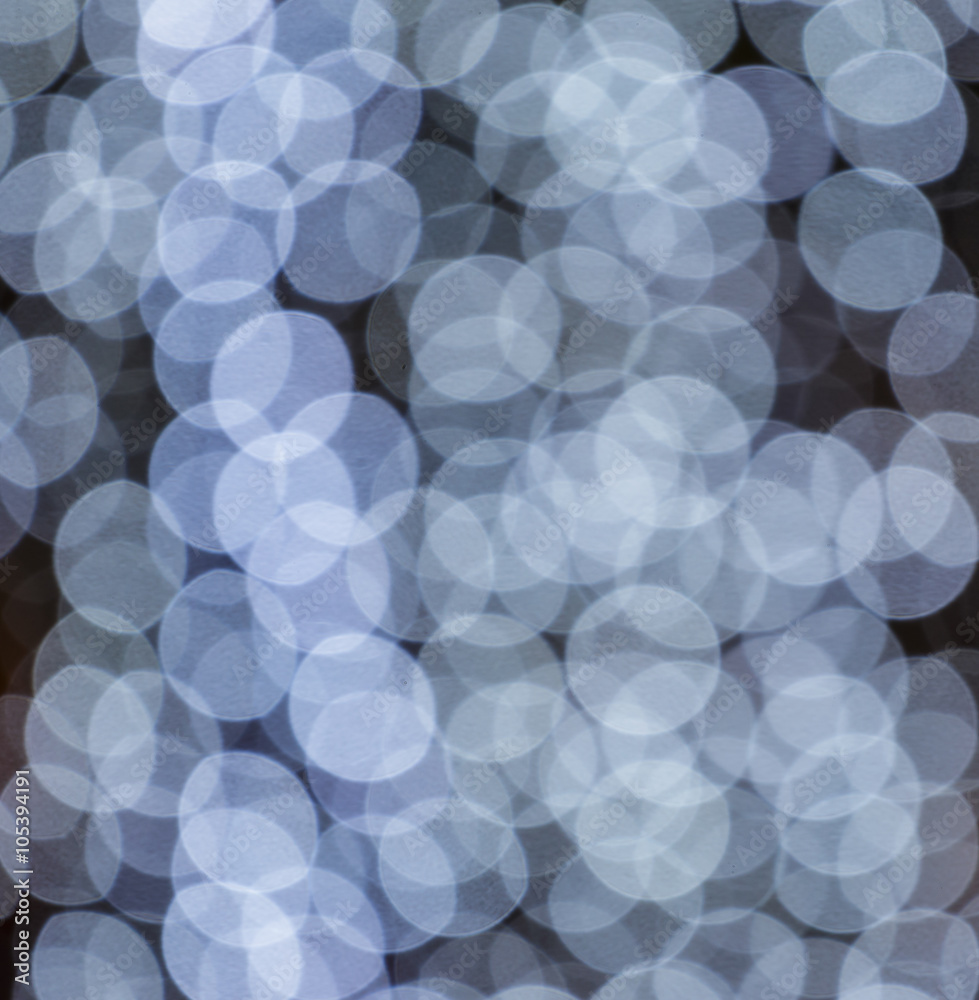White bokeh lights on black background