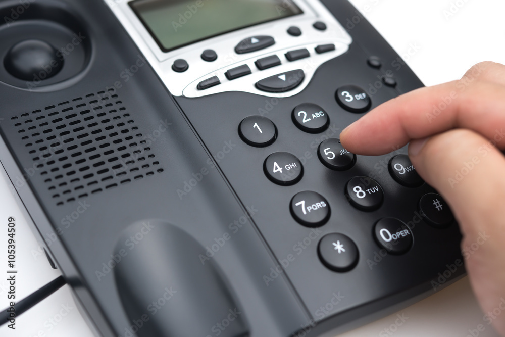 man dialing a black telephone close up man dialing a black telephone close up