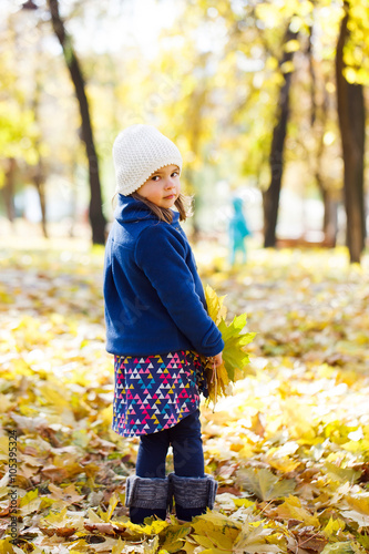 little girl keeps leafs in hand in park in the autumn © davit85