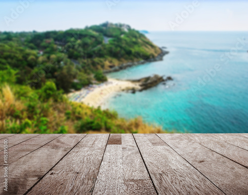 Wood table top on blurred blue sea and island view point