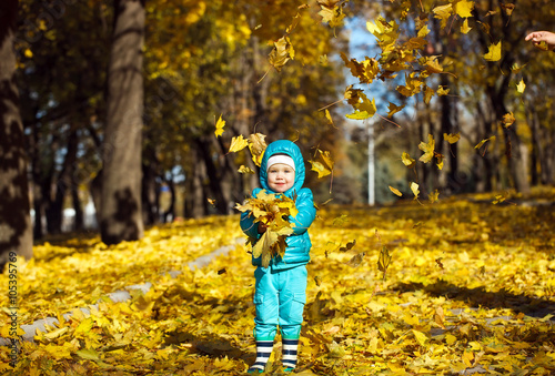 little girl throwing autumn leaves © davit85