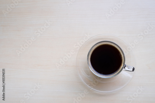 Top view of black coffee on wooden table