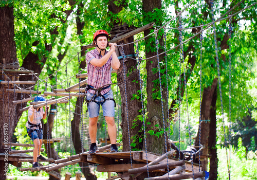 adventure climbing high wire park - people on course in mountain