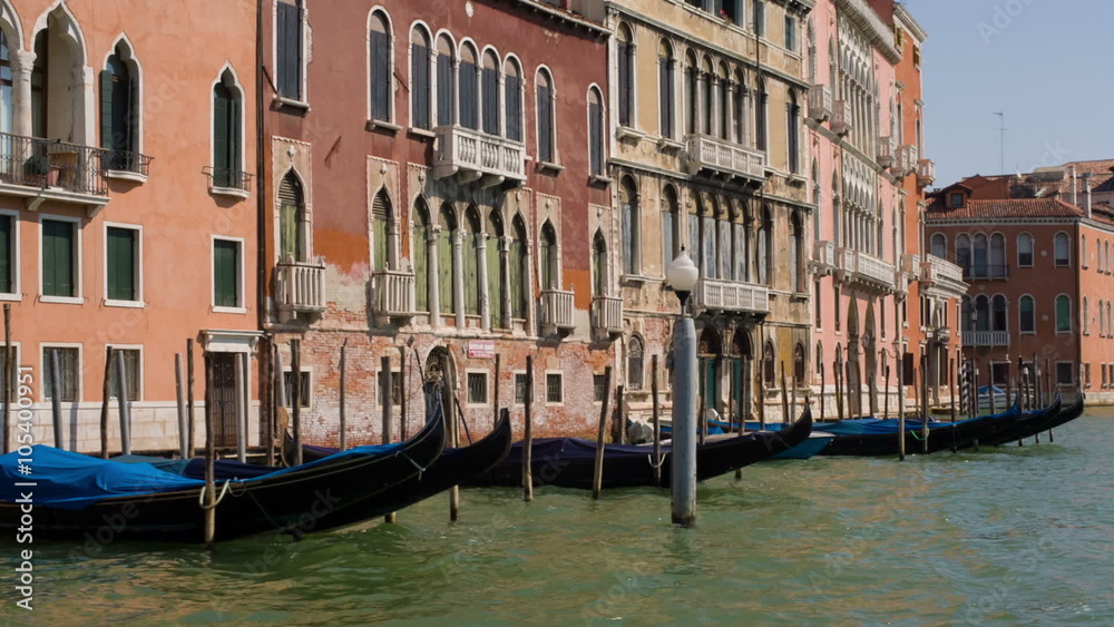Gondolas moored along a canal in Venice, Italy Gondolas moored along a canal in Venice, Italy