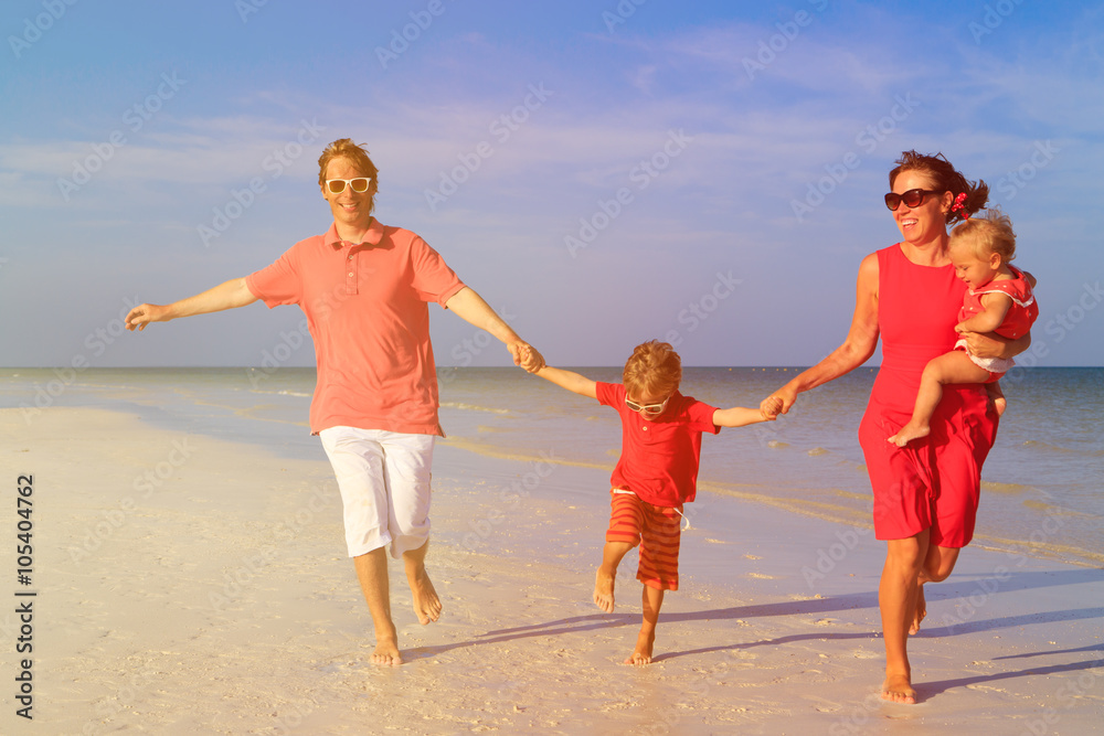 family with two kids having fun on tropical beach family with two kids having fun on tropical beach