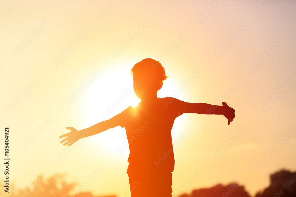 silhouette of happy little boy at sunset silhouette of happy little boy at sunset