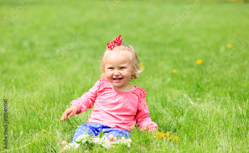 cute happy little girl with flowers in spring