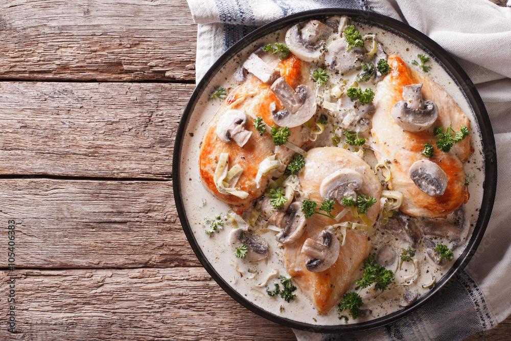 Chicken breast with mushrooms in cream sauce horizontal top view
