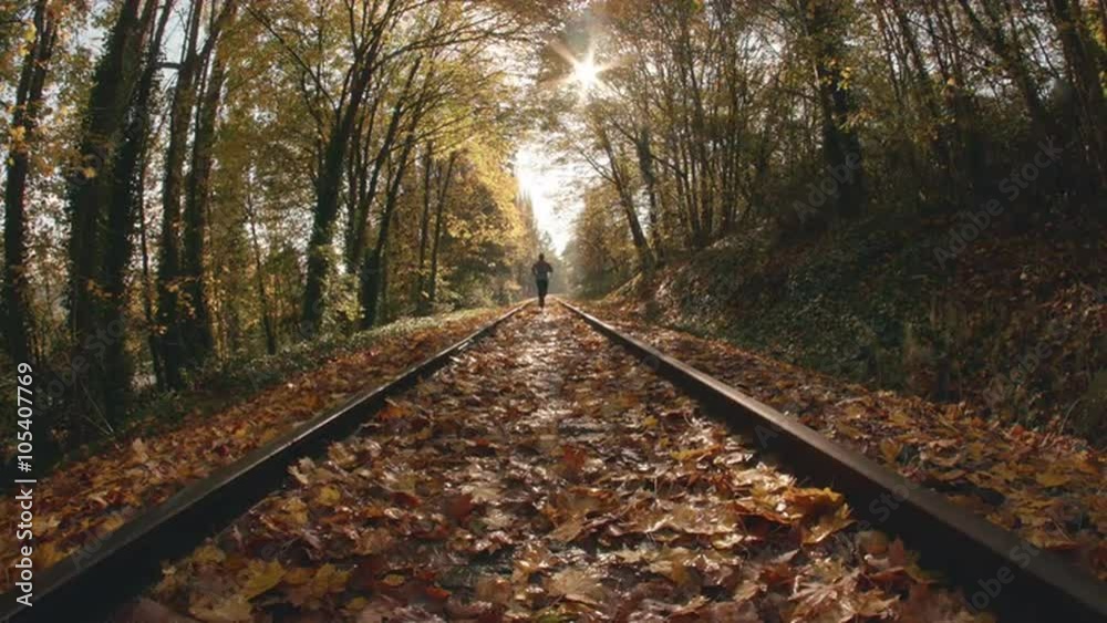 Fisheye POV Angle of Man Jogging Down Train Tracks in Fall Season Fisheye POV Angle of Man Jogging Down Train Tracks in Fall Season