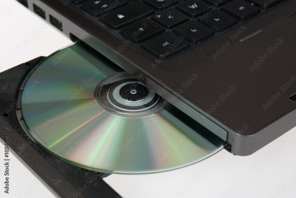 close up image of computer and cd and dvd close up image of computer and cd and dvd