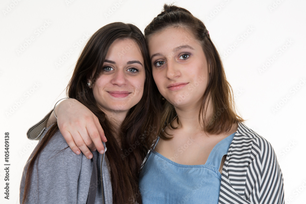 studio picture of two brunette sisters isolated on white studio picture of two brunette sisters isolated on white