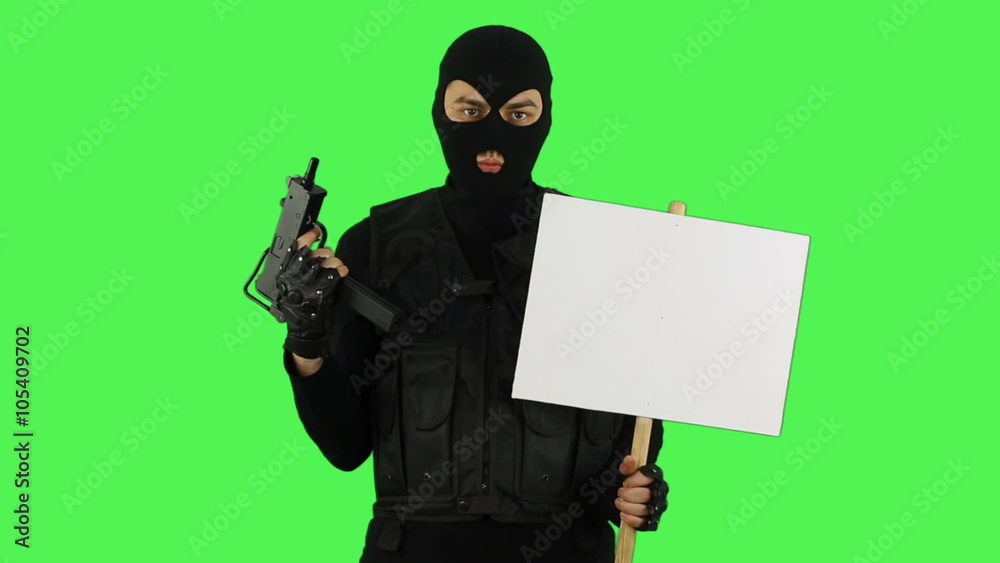 Terrorist with sign on green screen Terrorist with sign on green screen