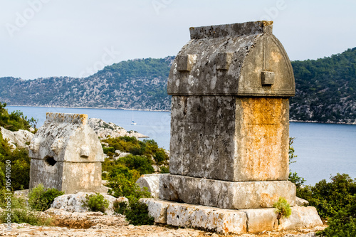 Lycian tombs in Simena on a hill above the sea. photo