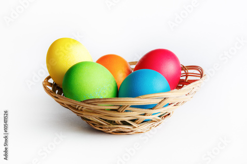 Bright Easter eggs in basket. Colorful easter eggs.