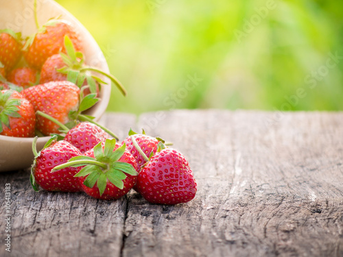 Stawberry on the wood plate.. photo