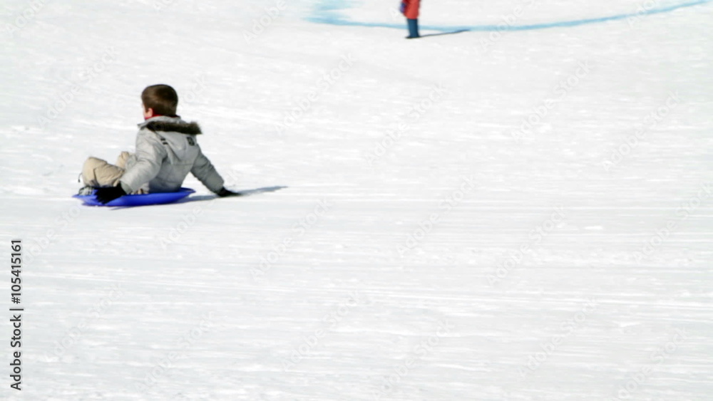 slow motion two happy child that falls on snow with sledge slow motion two happy child that falls on snow with sledge