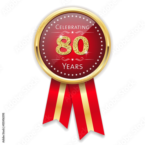 Red celebrating 80 years badge, rosette with gold border and ribbon