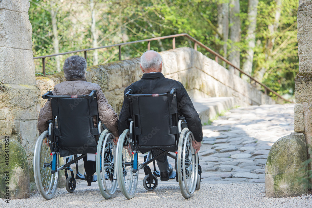 elderly couple on their wheelchair elderly couple on their wheelchair