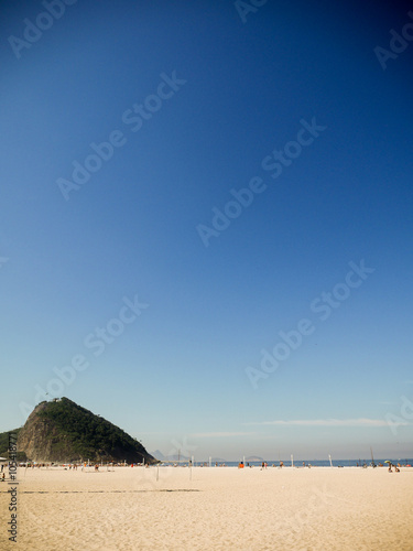 Praia do Leme  Rio de Janeiro  Brazil. A view of the beach and hill in the Leme district of Rio with clear blue sky copy space.
