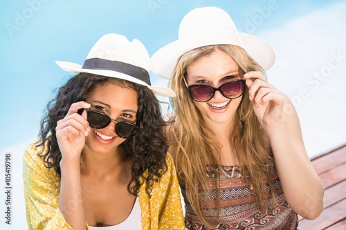 Young women wearing sunglasses having fun near pool © WavebreakmediaMicro