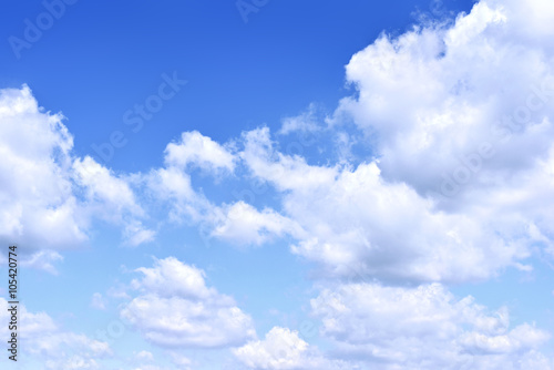 Blue sky with white cumulus clouds. Cloudscape in the sun  good weather with copy space. Nature background with clear blue sky and fluffy clouds.