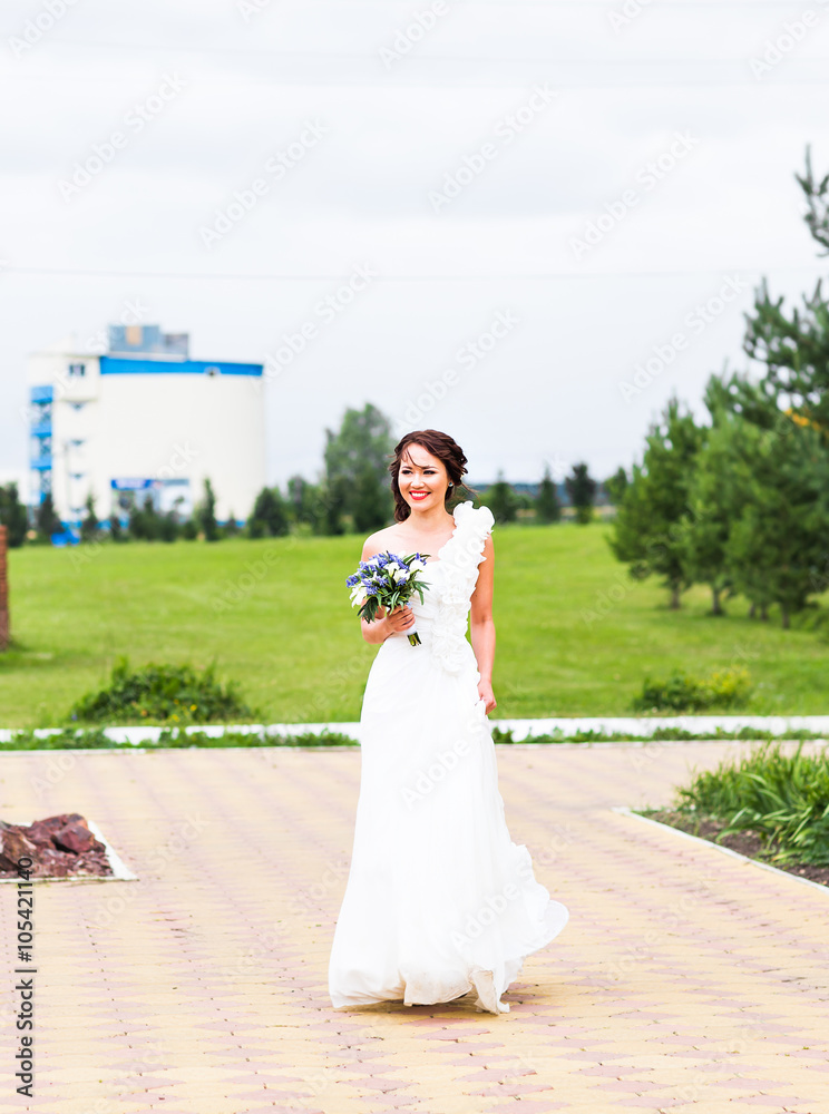 Bride holding bouquet of white calla lilies and blue flowers Bride holding bouquet of white calla lilies and blue flowers