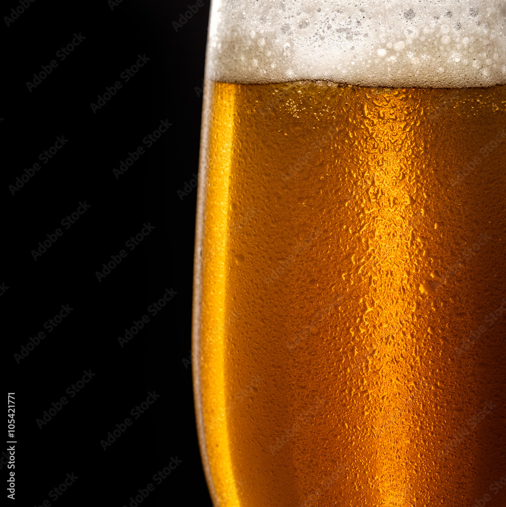Water drops on a glass of beer Water drops on a glass of beer