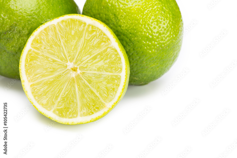 Group of fresh limes on white wooden surface