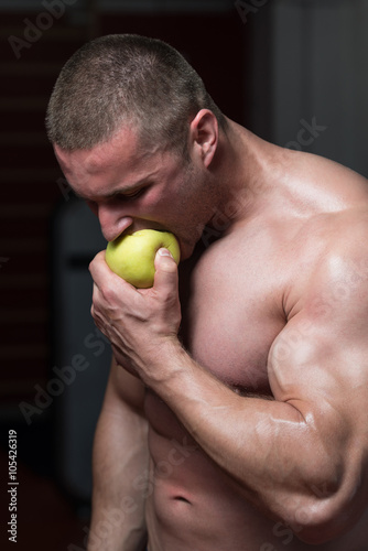 Bodybuilder Man Eating An Apple