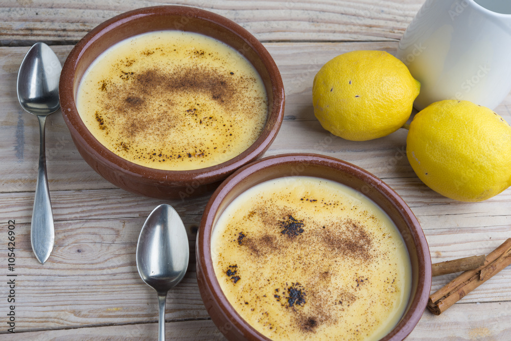 Traditional creme brulee on ceramic dish on wooden table Traditional creme brulee on ceramic dish on wooden table